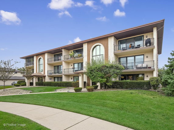 Front view of a multi-story building with balconies.