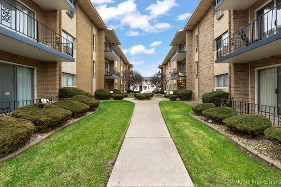 Front view of two apartment buildings facing each other with balconies.