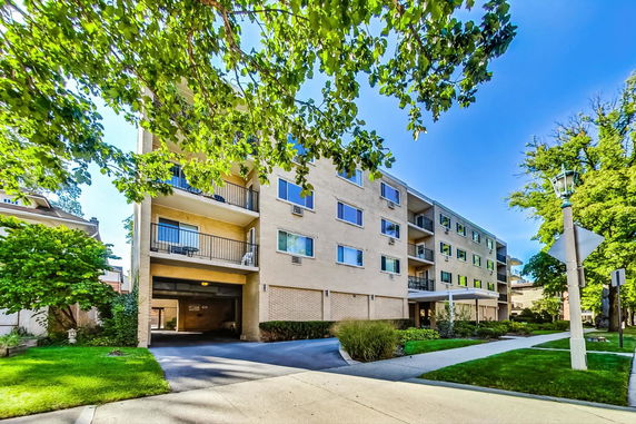 Front view of a multi-story apartment building with balconies.