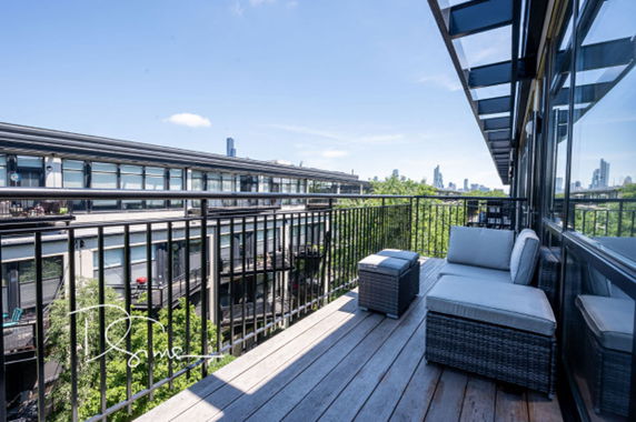 View from a balcony overlooking a modern residential building complex.