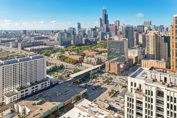 Panoramic view of a cityscape with multiple skyscrapers and surrounding buildings.