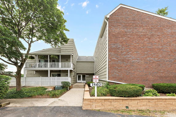 Front view of a two-story building with brick and siding exterior.