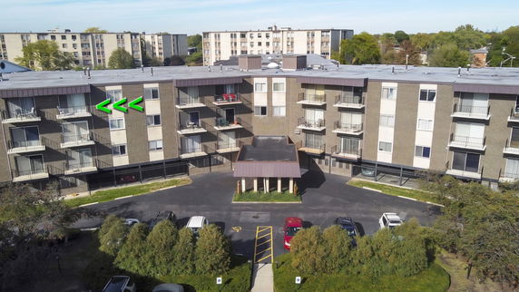 Front view of a multi-story residential building with balconies.