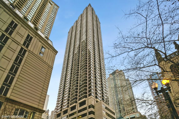 View of a tall skyscraper from ground level looking up.