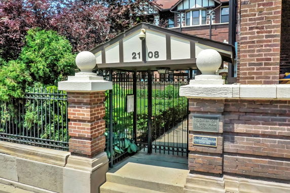 Front view of a brick building with a gated entrance