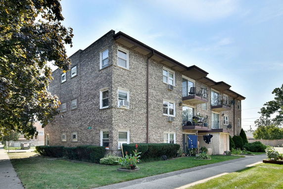 Front view of a three-story brick apartment building.
