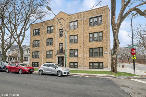 Front view of a multi-story brick apartment building.