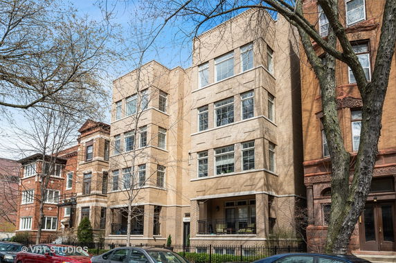 Front view of a multi-story brick apartment building.