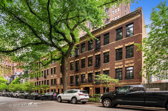 Front view of a multi-story brick building with ornamental details.