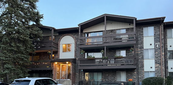 Front view of a multi-story apartment building with balconies.