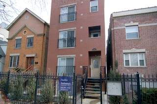 Front view of a three-story brick apartment building.