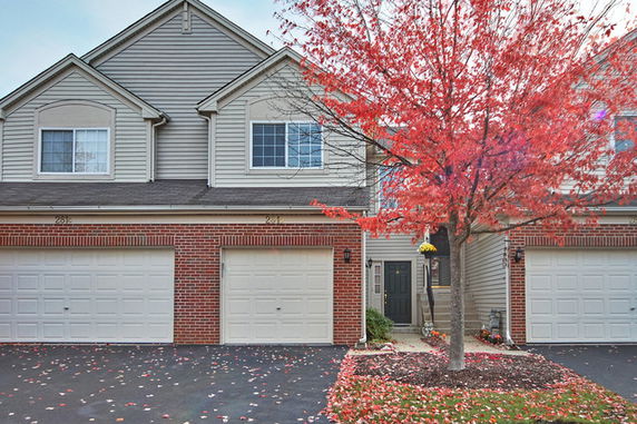 Front view of a two-story house with a double garage and brick exterior.