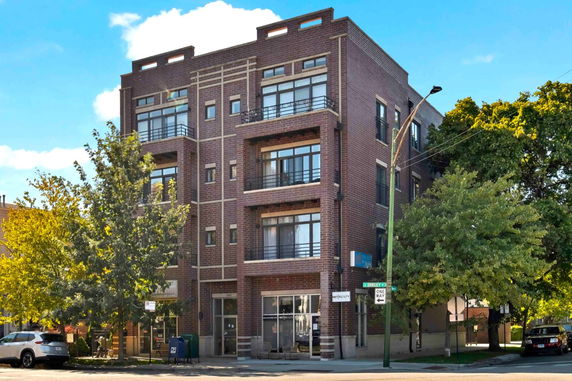Front view of a four-story brick apartment building.