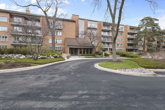 Front view of an apartment building with multiple floors and balconies.