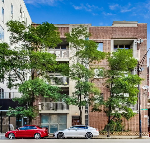 Front view of a multi-story brick apartment building.