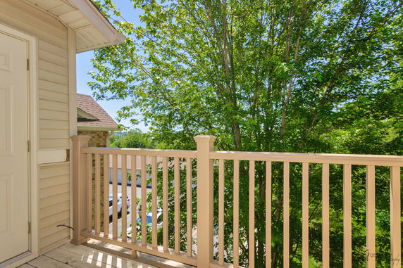 View from a building showing a balcony railing and trees outside.