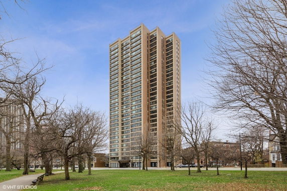 View of a high-rise apartment building with multiple floors and large windows.