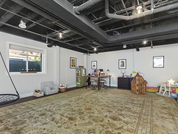 Indoor play area with toys and children's furniture.