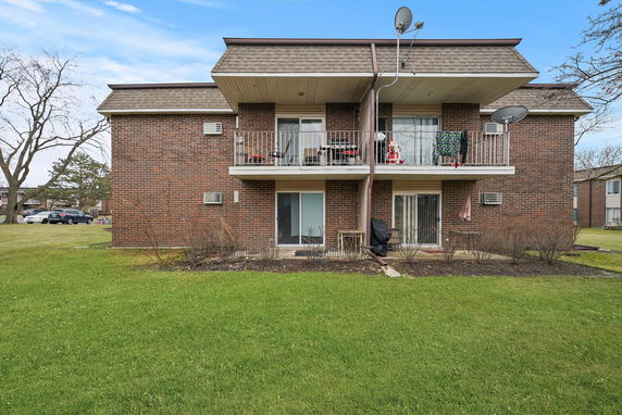 Front view of a two-story brick building with balconies.