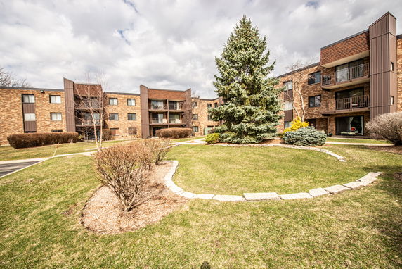 Front view of a multi-story apartment building with balconies.