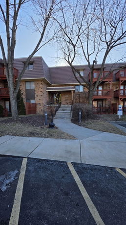 Front view of a multi-story residential building with balconies.