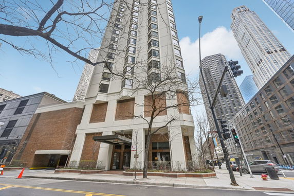 Front view of a tall skyscraper with modern architectural design.