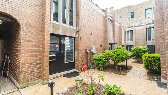 Front view of a brick townhouse with multiple entrances.