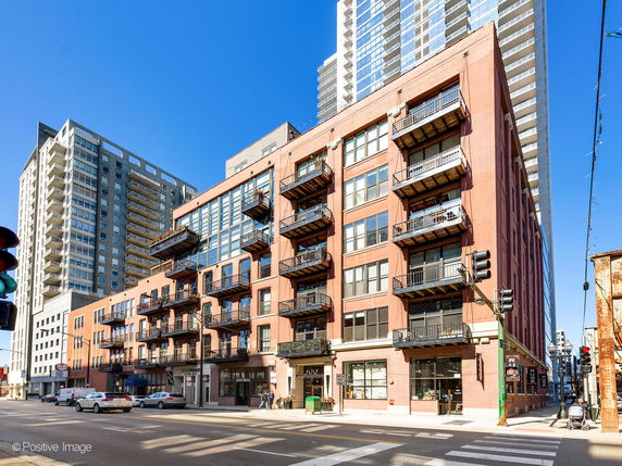 Front view of a multi-story residential building with balconies.