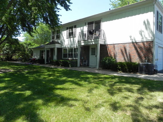 Front view of a two-story house with a brick and white exterior.