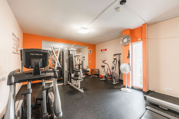 Interior view of a gym with various exercise equipment.