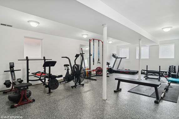 Indoor gym area with various exercise equipment.