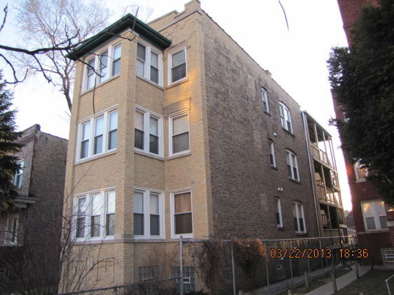 Front view of a three-story brick apartment building.