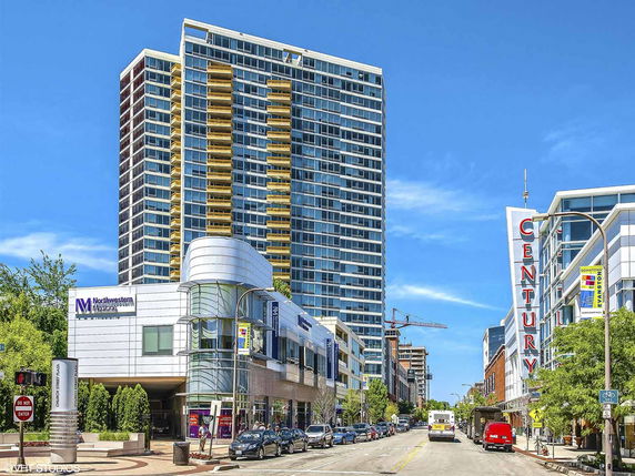 Front view of a high-rise building with multiple floors and a contemporary design.
