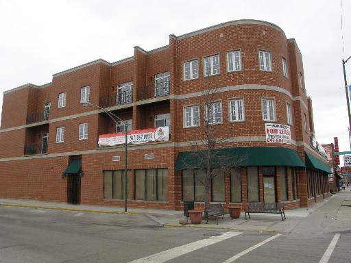 Front view of a commercial building with multiple levels and large windows.
