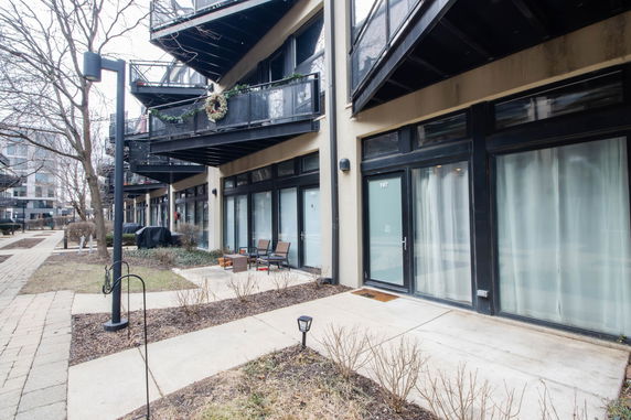 View of a multi-story building with balconies and large glass doors.