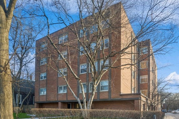 Front view of a multi-story brick apartment building.