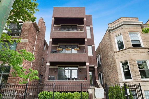 Front view of a multi-story brick apartment building.