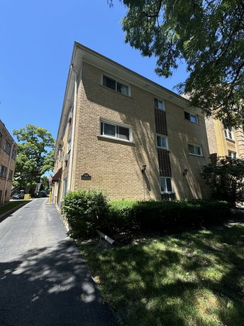Front view of a multi-story brick apartment building.
