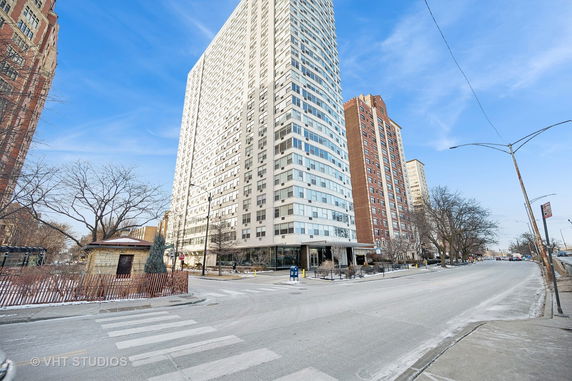 Front view of a tall residential building on a city street.