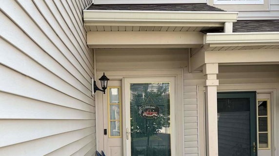 Front view of a house entrance with a glass door.