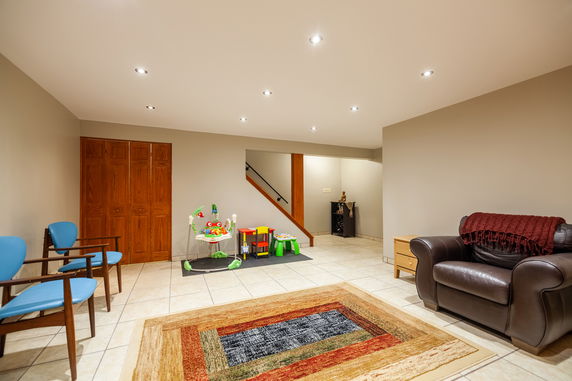 Room with children's play equipment and seating area.