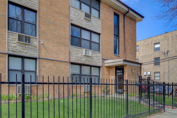 Front view of a building with a brick exterior and multiple windows.