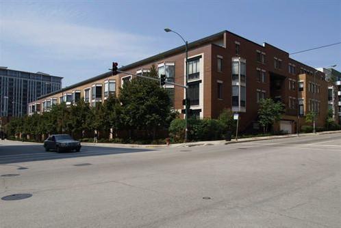 Front view of a multi-story building at a street corner.