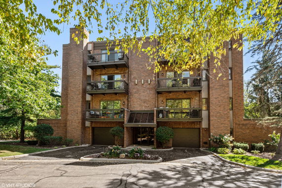 Front view of a multi-story brick building with balconies.