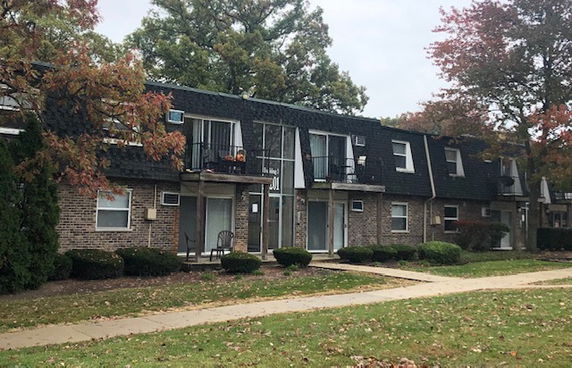 Front view of a two-story apartment building with brick exterior.