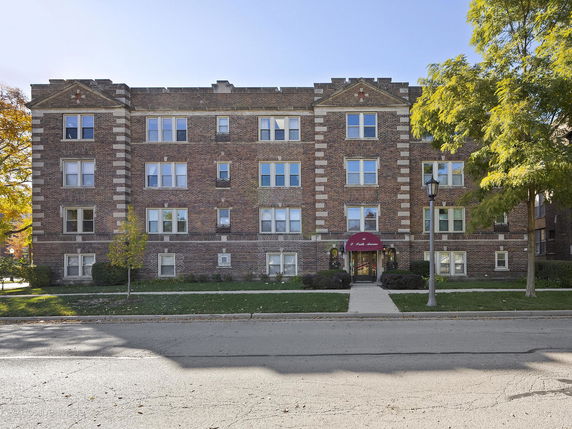 Front view of a multi-story brick apartment building.
