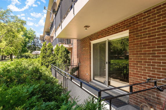 Exterior view of a multi-story brick building with balconies.