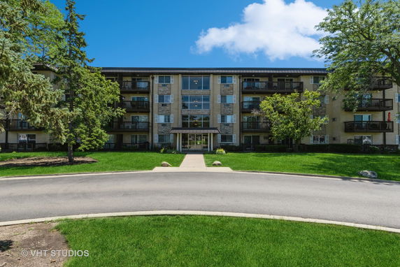 Front view of a multi-story residential building with balconies.