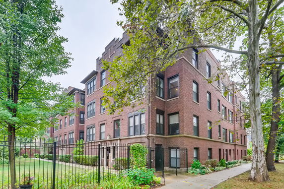 Front view of a multi-story brick apartment building.