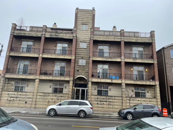Front view of a multi-story residential building with balconies.
